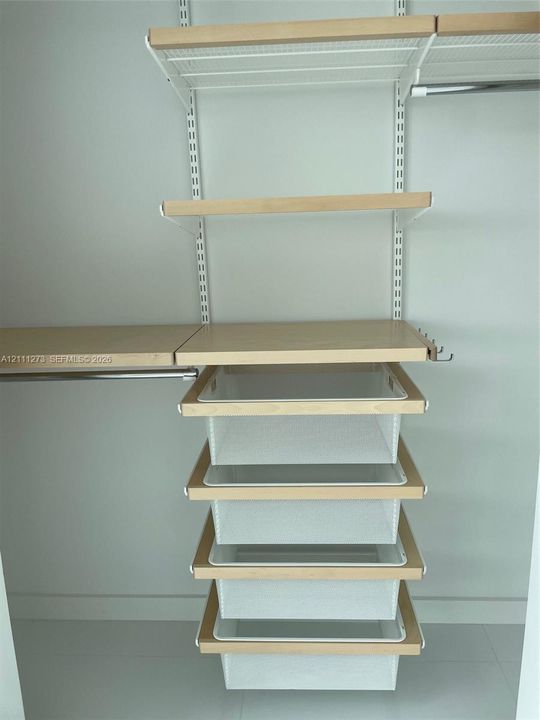 Customized closet in the second bedroom.
