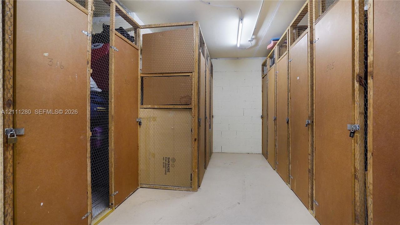 Dedicated storage area featuring enclosed wooden locker units with wire mesh paneling and secure padlock hasps
