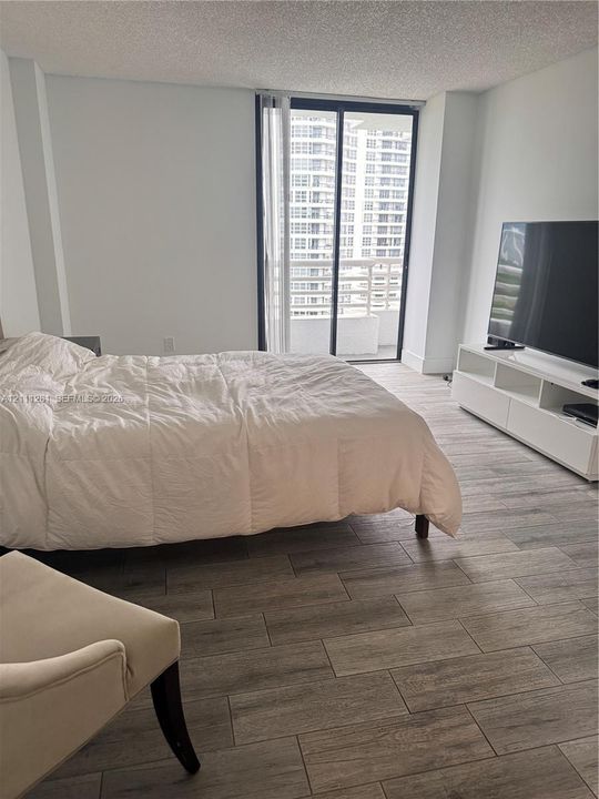 porcelain-finish tflooring, sliding glass balcony doors, and neutral wall tones