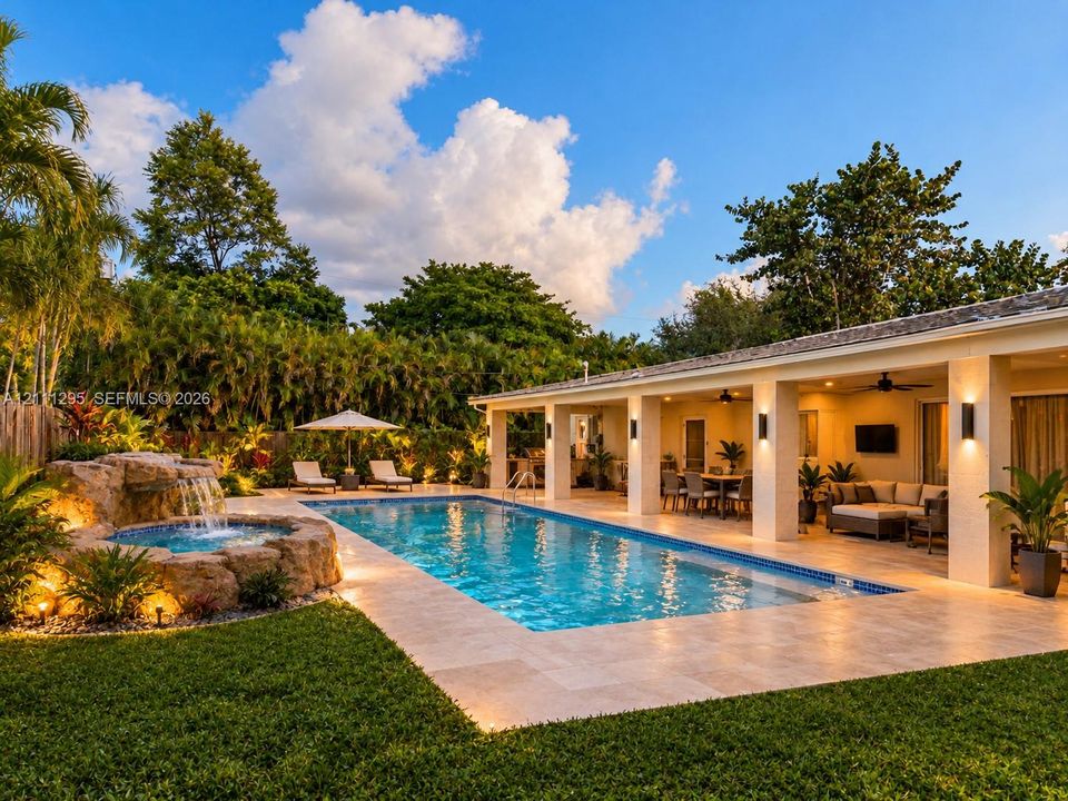 Conceptual rendering - Outdoor living area featuring a swimming pool, integrated stone waterfall spa, expansive stone-paver patio, and covered loggia