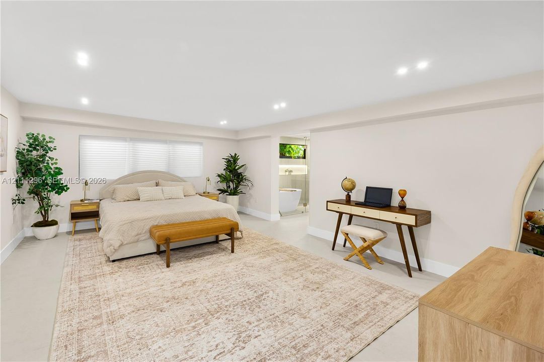 Spacious room featuring neutral wall tones, recessed lighting, expansive multi-pane horizontal windows, and smooth-finish flooring