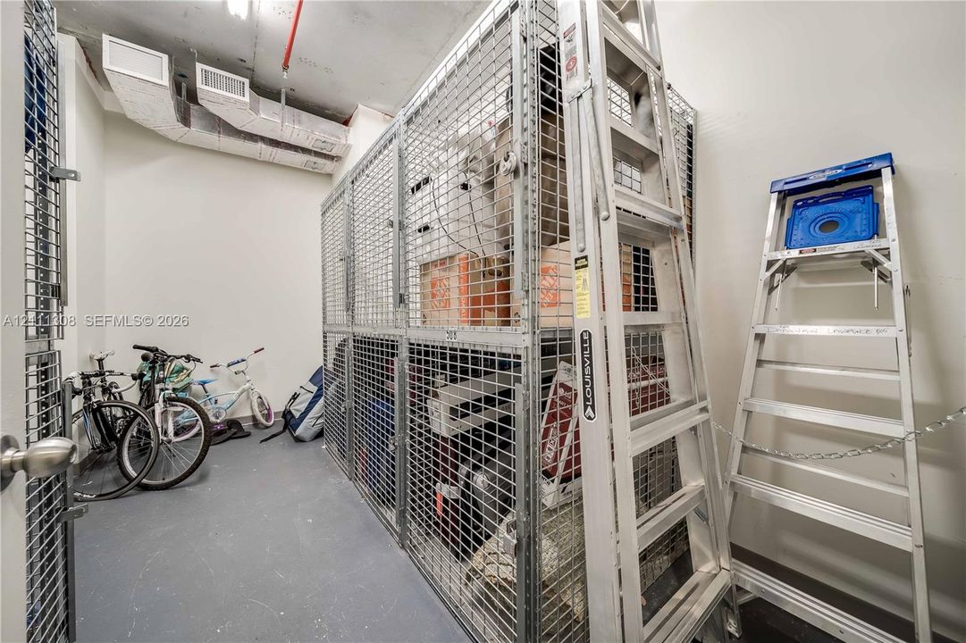 Dedicated storage unit featuring floor-to-ceiling metal mesh partitioning and durable concrete flooring