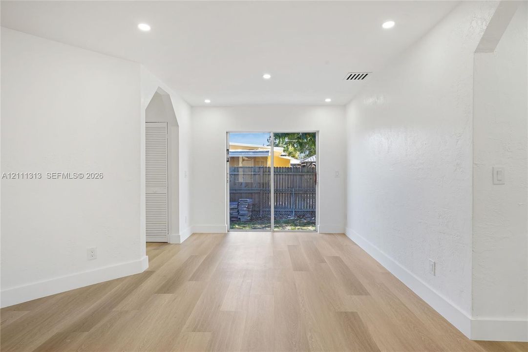 Interior space featuring wood-finish flooring, recessed lighting, and a glass sliding door