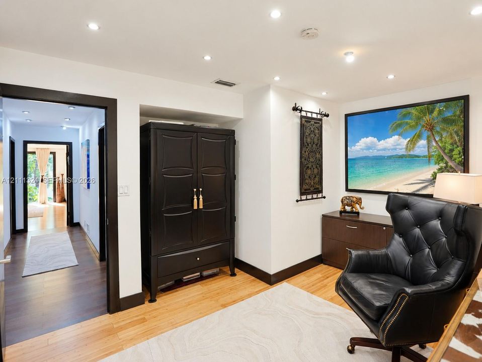 Interior space featuring wood-finish flooring, recessed ceiling lighting, and contrasting finished door trim