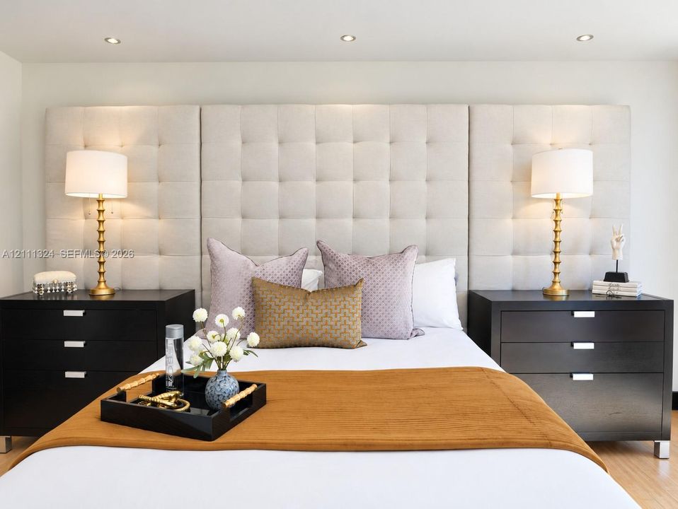 Full-height upholstered tufted headboard featuring integrated recessed ceiling lighting