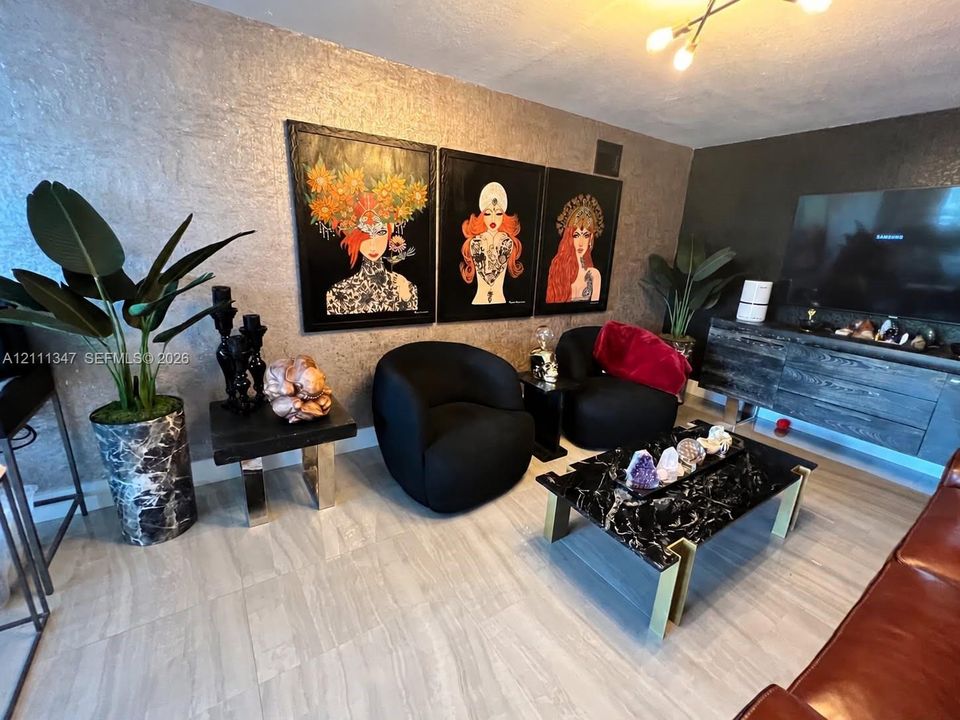 Metallic textured wall finish featuring large-format tile flooring and an attached multi-arm ceiling fixture