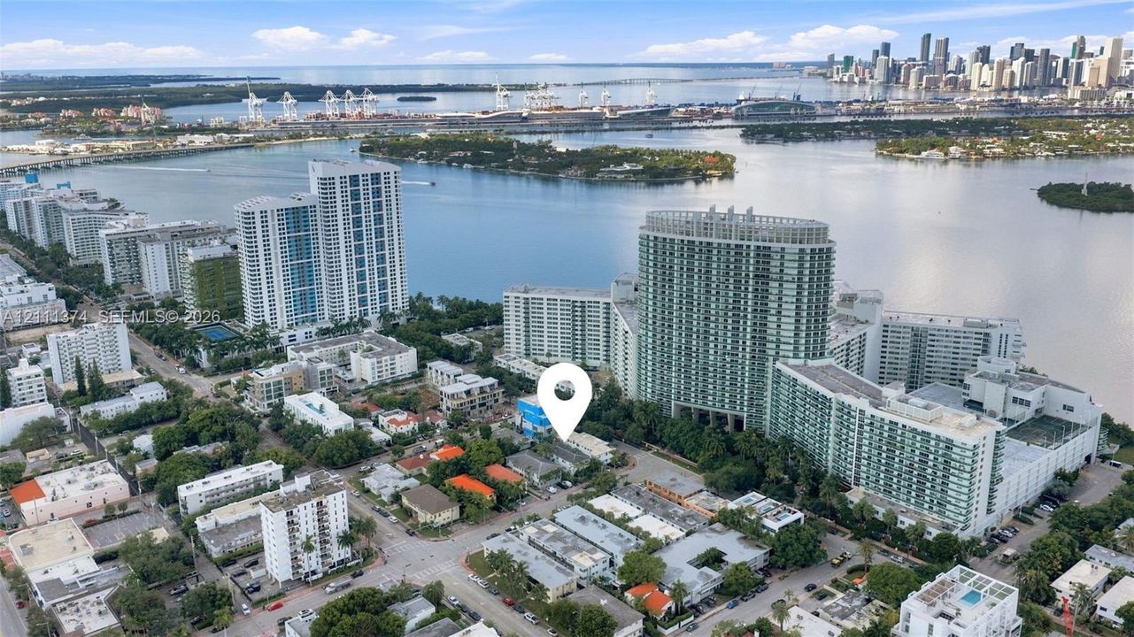 Aerial perspective of a coastal urban setting featuring a proximity to waterways and city skyline