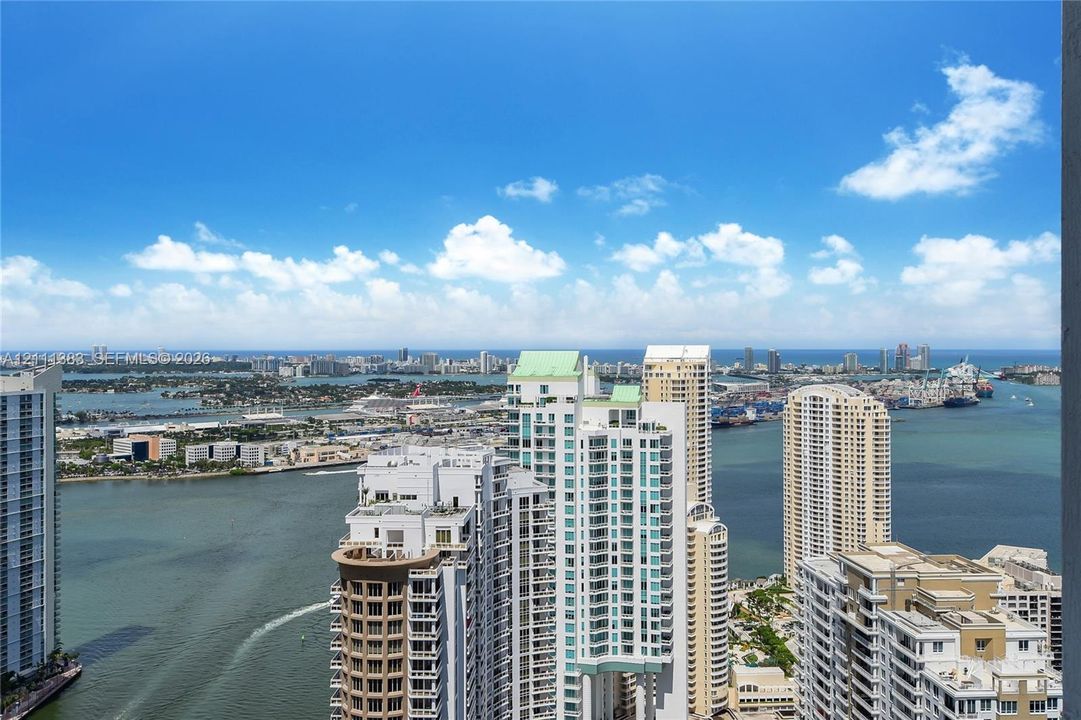 High-altitude perspective featuring expansive water and urban skyline scenery