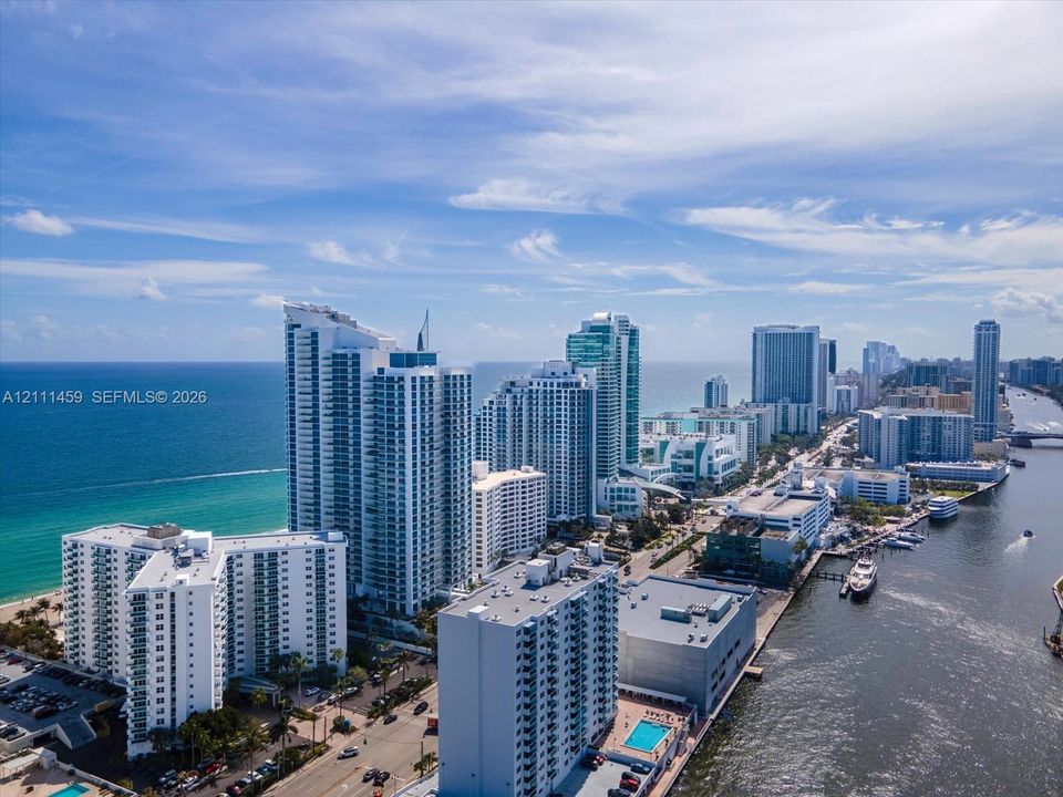 Aerial perspective featuring waterfront high-rise architecture, proximity to the Atlantic coastline, and maritime access along the canal