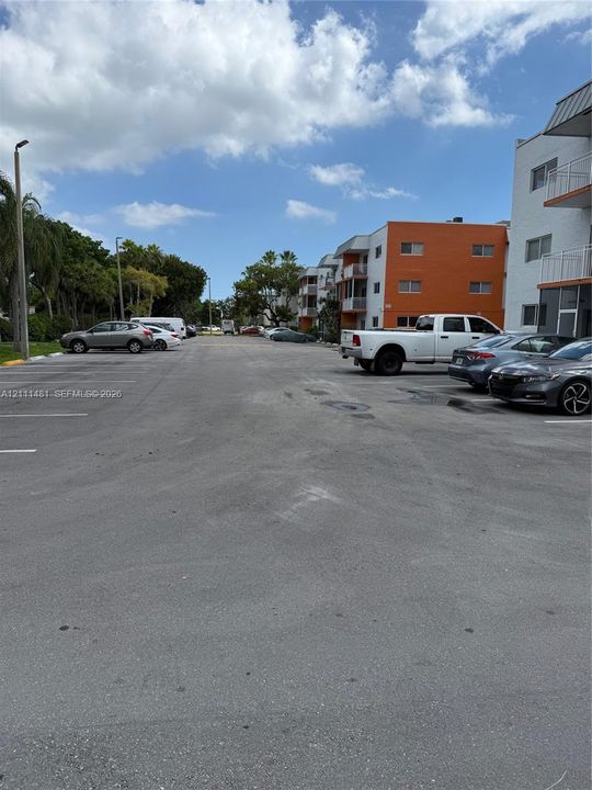 Asphalt surface parking lot featuring marked parking stalls and pole-mounted exterior lighting