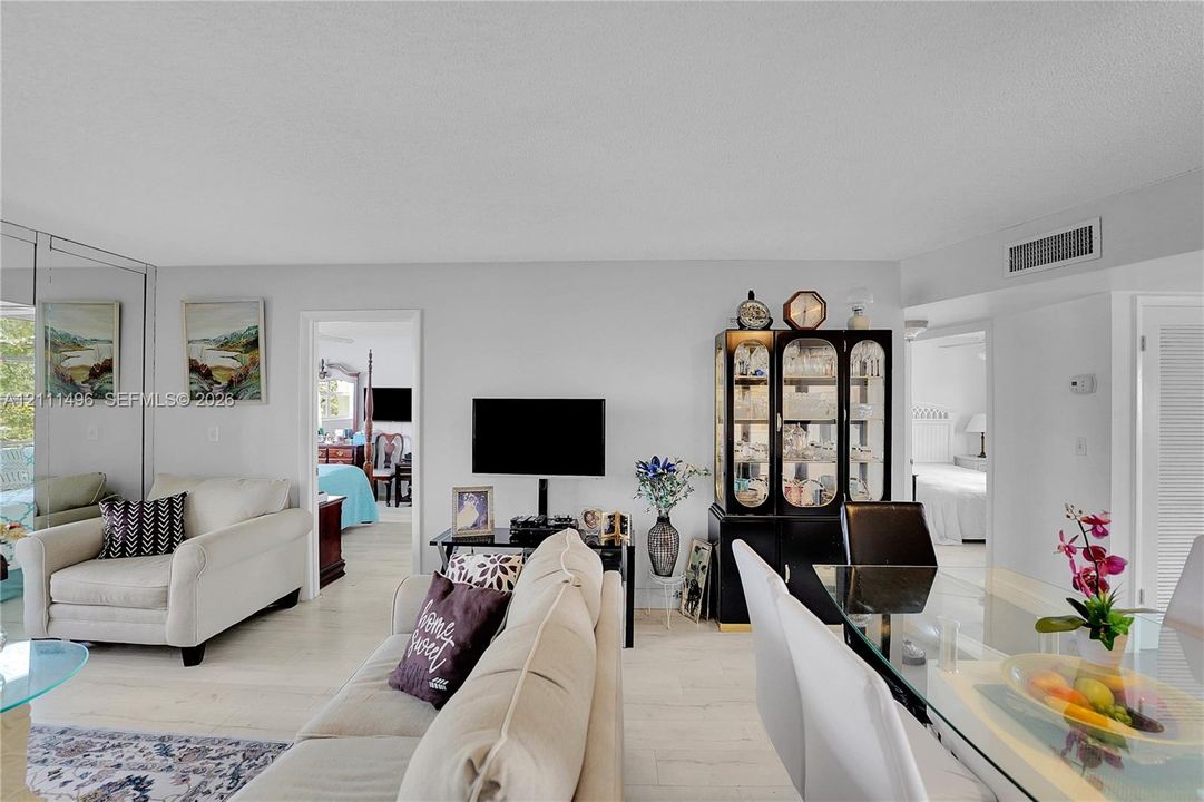 Neutral-toned walls, wood-finish flooring, and wall-to-wall mirrored panels