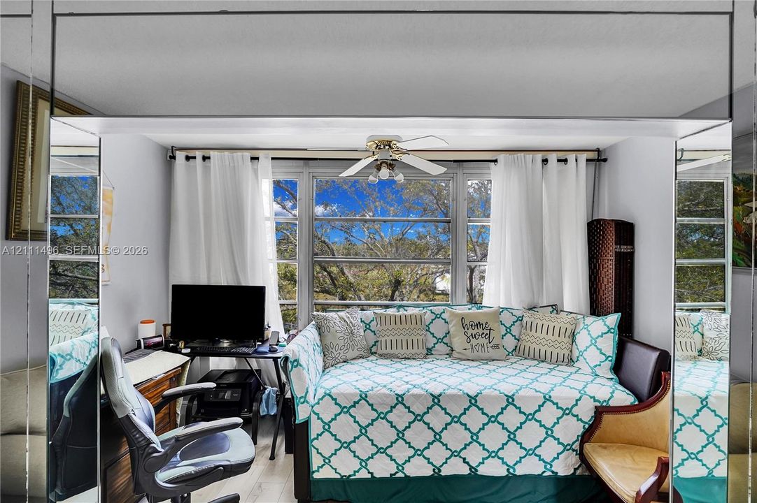 Full-height wall mirrors, large multi-pane windows, and a ceiling-mounted light fixture