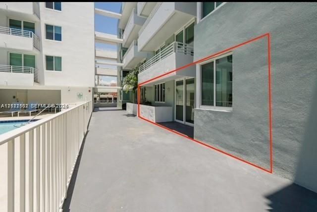 Private patio featuring smooth concrete flooring and sliding glass door access