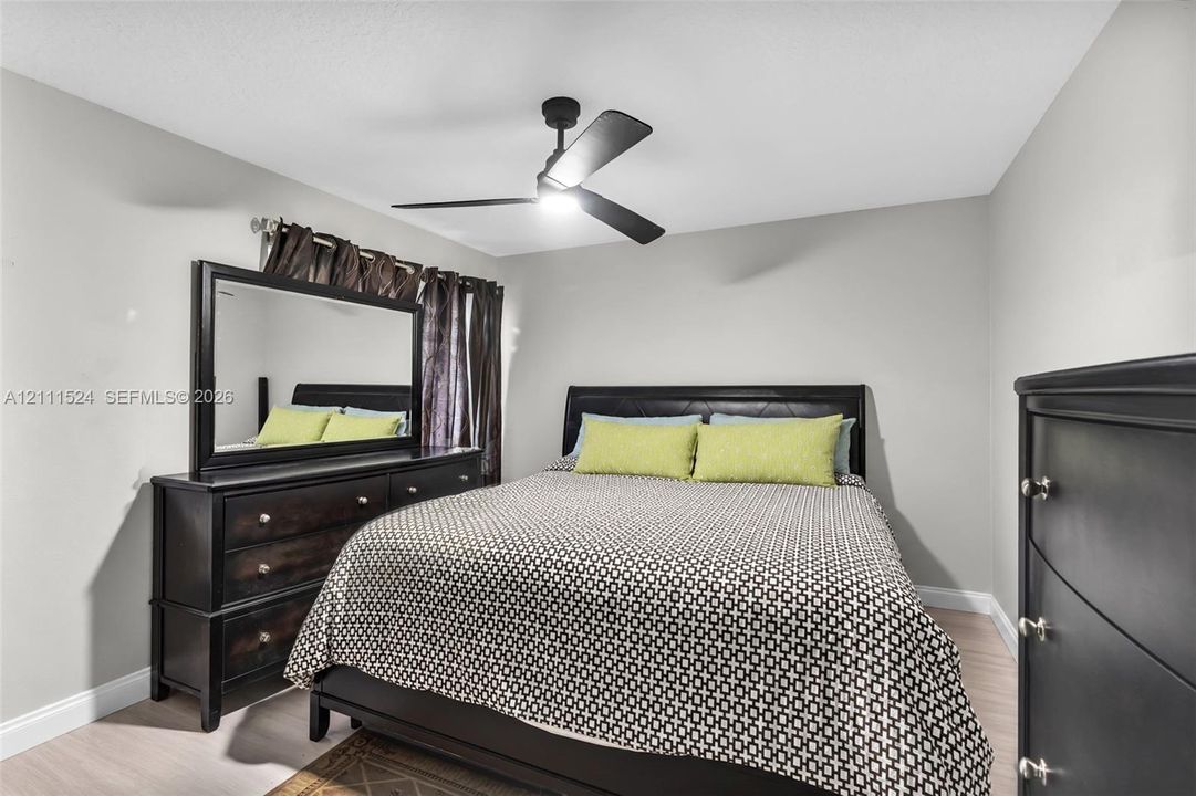 Matte black ceiling fan with integrated lighting and neutral-toned wall paint