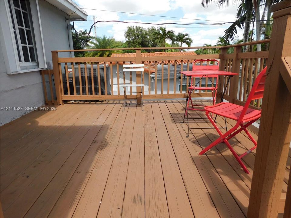 Elevated wood-plank deck featuring a perimeter wood railing