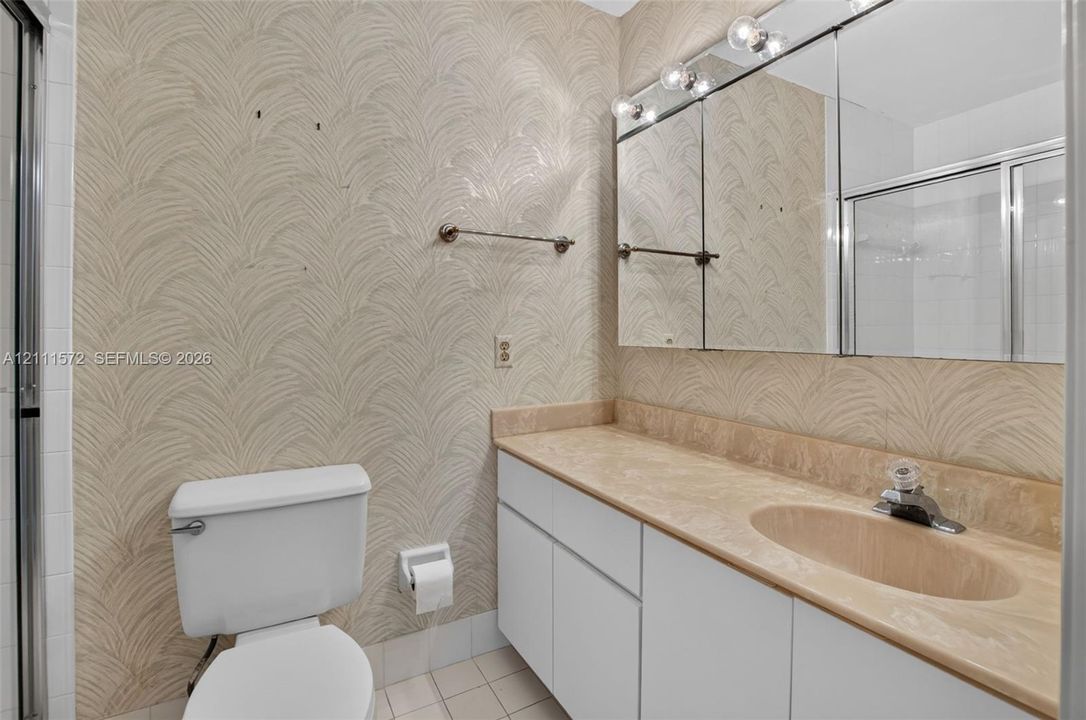 Bathroom with two medicine cabinet, overhead bar lighting, and heat lamp