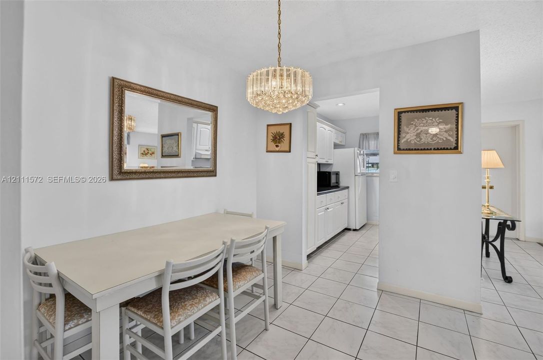 Dining area featuring tile flooring and a crystal-accented chandelier