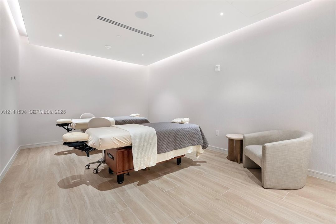 Neutral interior space featuring wood-finish flooring, recessed ceiling lighting, and perimeter cove lighting