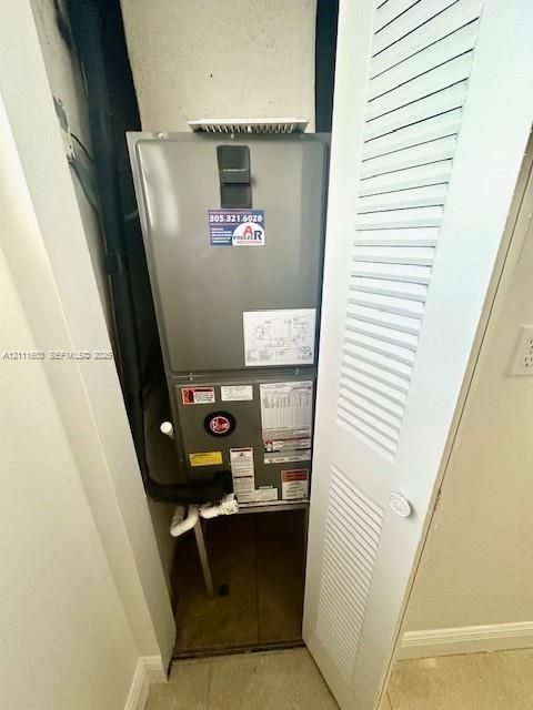 Climate control unit housed in a dedicated closet with a white louvered door