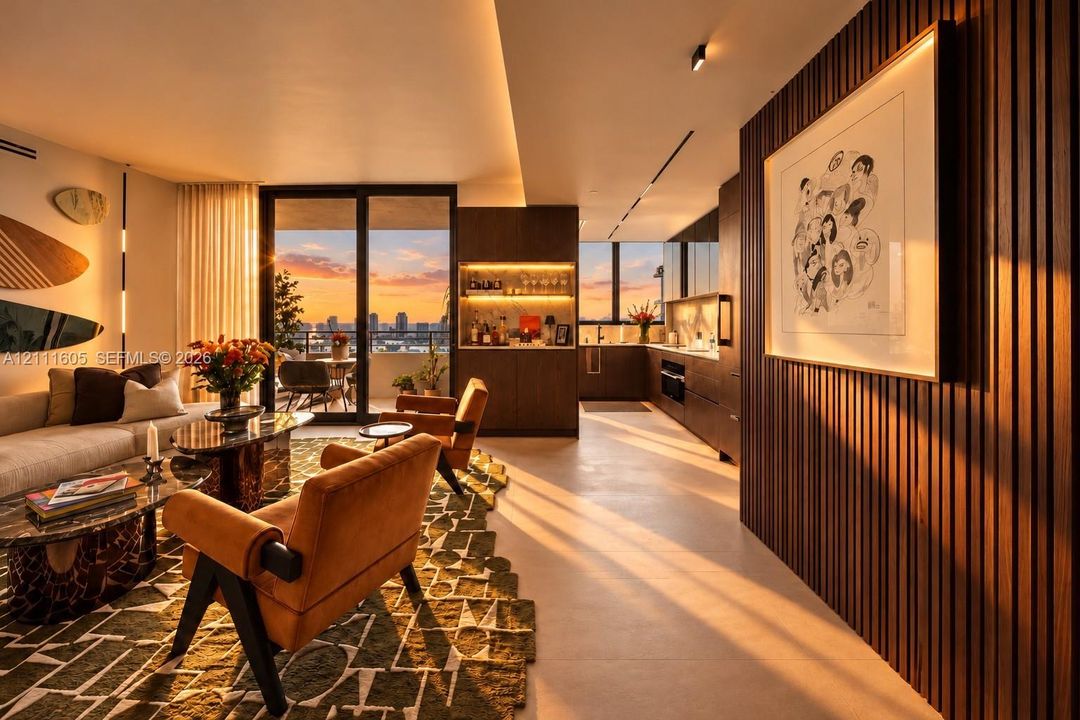 Open-concept interior featuring vertical wood-slat wall paneling, integrated recessed ceiling lighting, custom cabinetry, and large-format tile flooring, with floor-to-ceiling glass doors opening to an exterior balcony