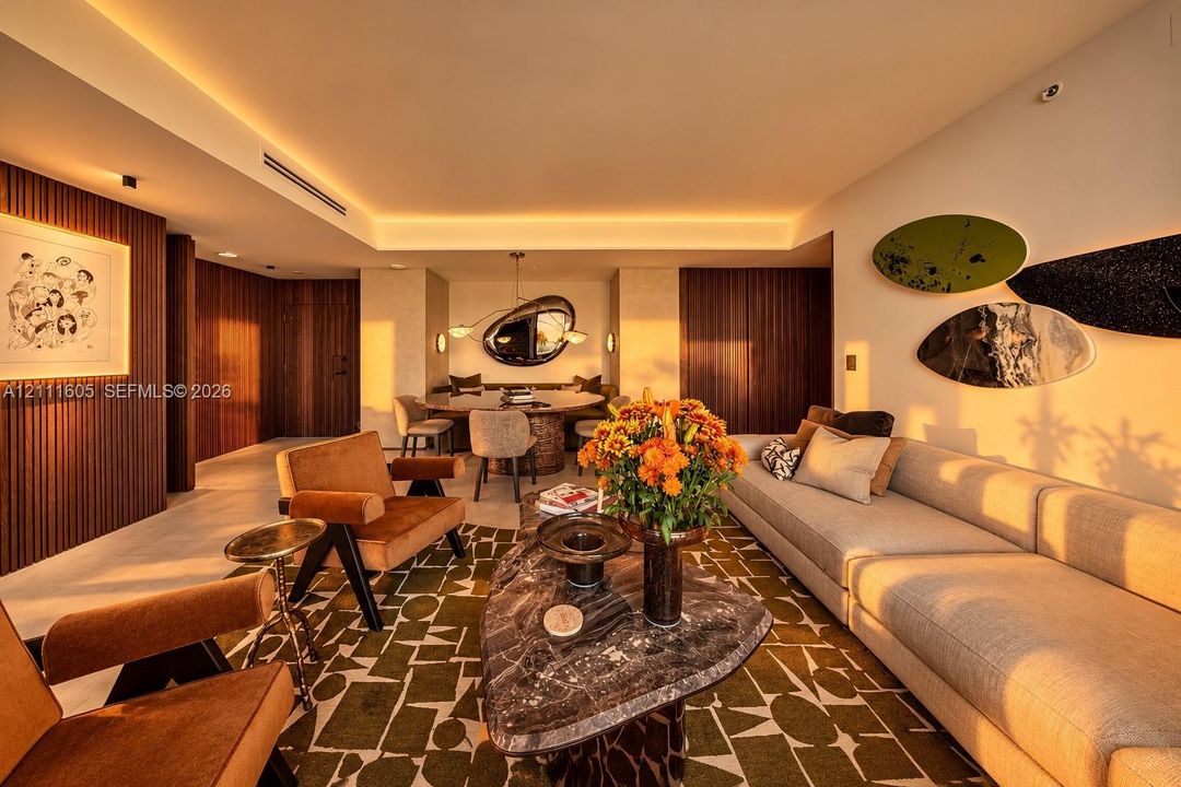 Interior space featuring vertical wood-slat wall paneling, recessed tray ceilings with perimeter accent lighting, and large-format tile flooring