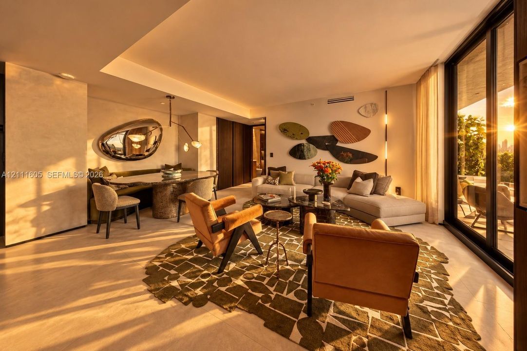 Open-concept interior featuring floor-to-ceiling sliding glass doors, neutral stone flooring, recessed ceiling lighting, and dark wood-finished cabinetry