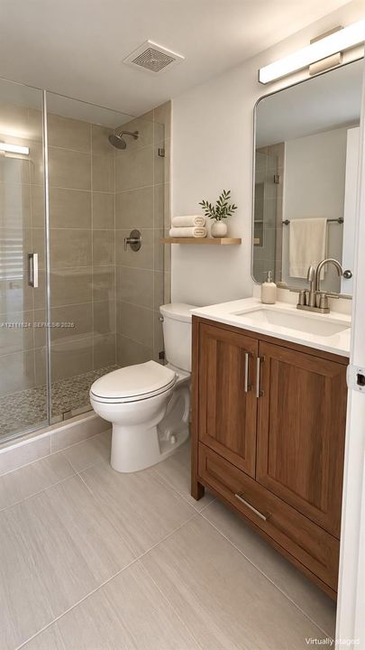 Beautifully updated bathroom featuring a glass enclosed shower with elegant tiled walls and modern finishes.