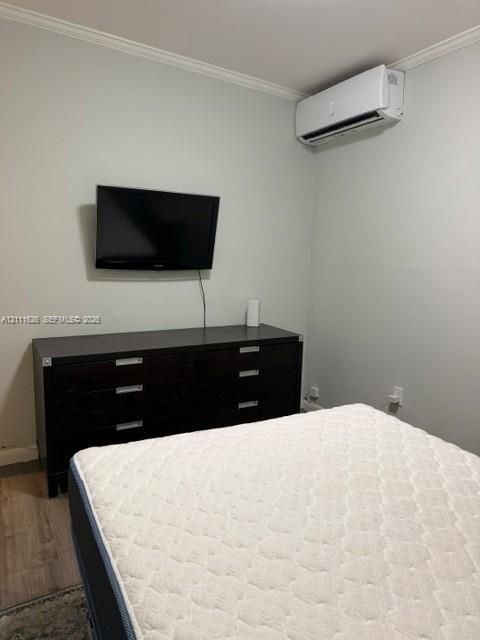 Wall-mounted ductless air conditioning unit, neutral wall paint, and wood-finish flooring
