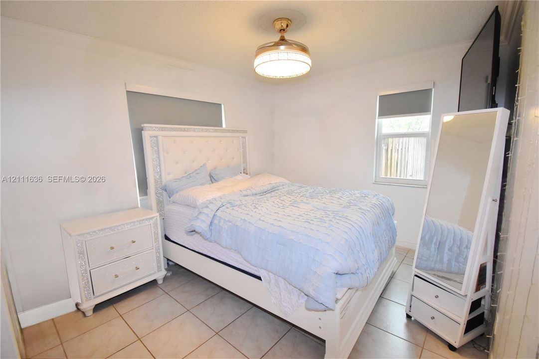 Tile flooring and ceiling-mounted drum light fixture with an integrated fan
