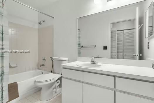 Bathroom featuring a white vanity cabinet, solid-surface countertop with an integrated basin, expansive wall-mounted mirror, and a tile-surround tub-shower combination