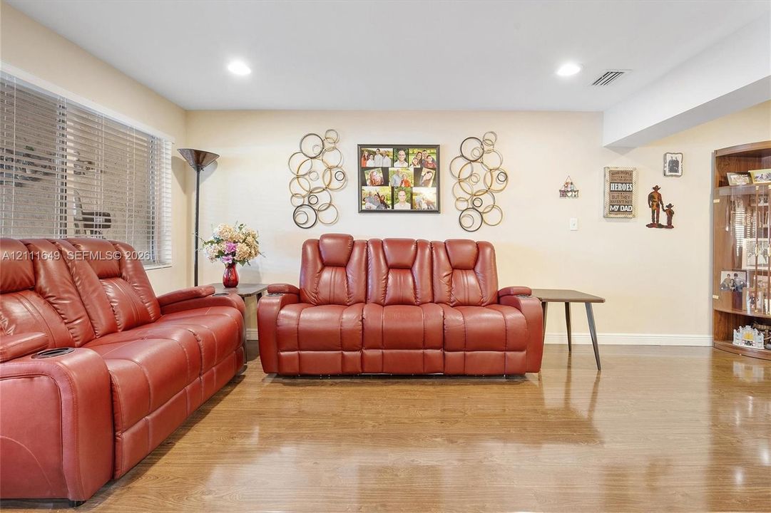 Wood-finish flooring, recessed lighting, and built-in wood cabinetry