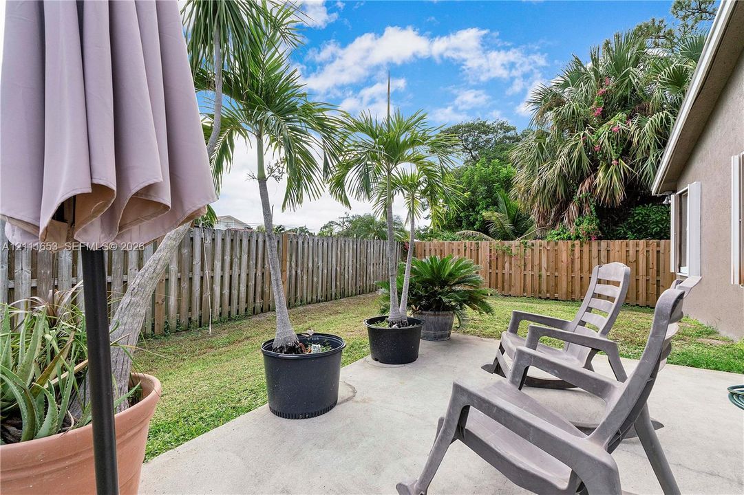 Rear concrete patio featuring a fenced yard