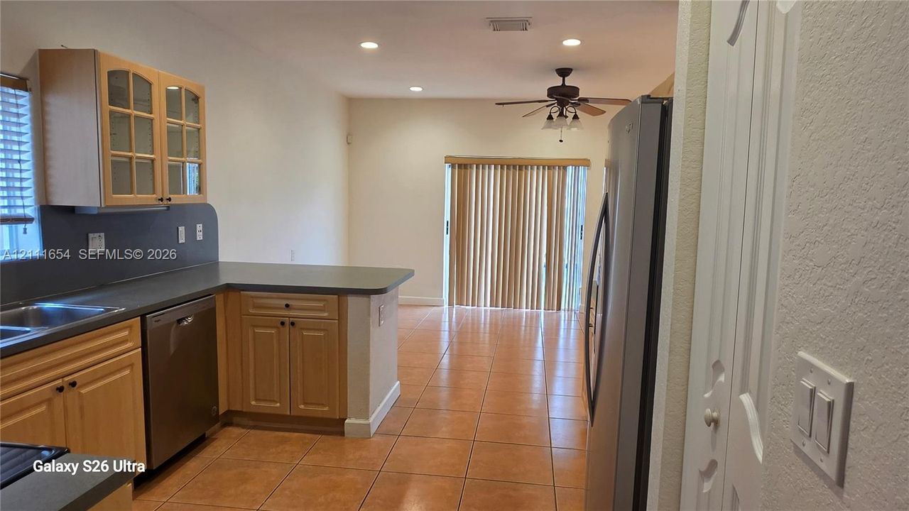 Kitchen featuring light wood cabinetry, recessed lighting, tile flooring, and stainless steel dishwasher