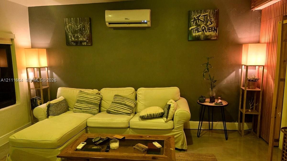 Wall-mounted mini-split climate control system and vertical wood-slat accent wall