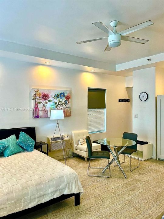 Tray ceiling featuring recessed lighting, a multi-blade ceiling fan, and ceramic tile flooring