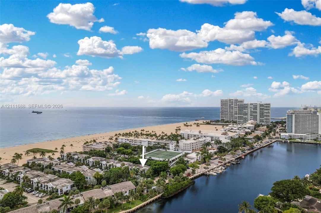 Aerial perspective featuring coastal proximity, oceanfront access, adjacent waterway, and mature tropical landscaping