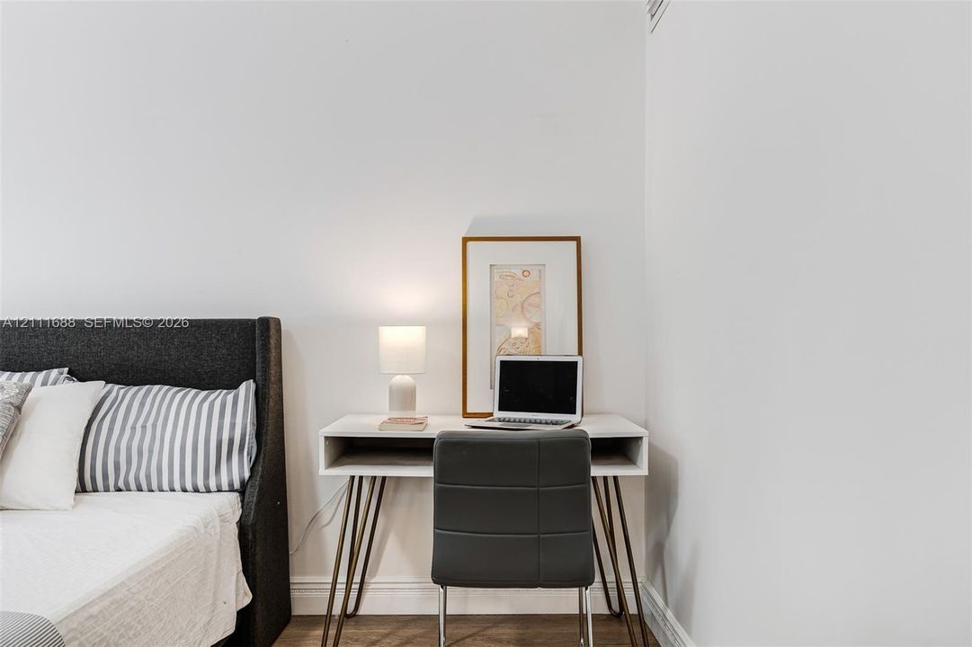 Neutral interior featuring white walls and wood-finish flooring