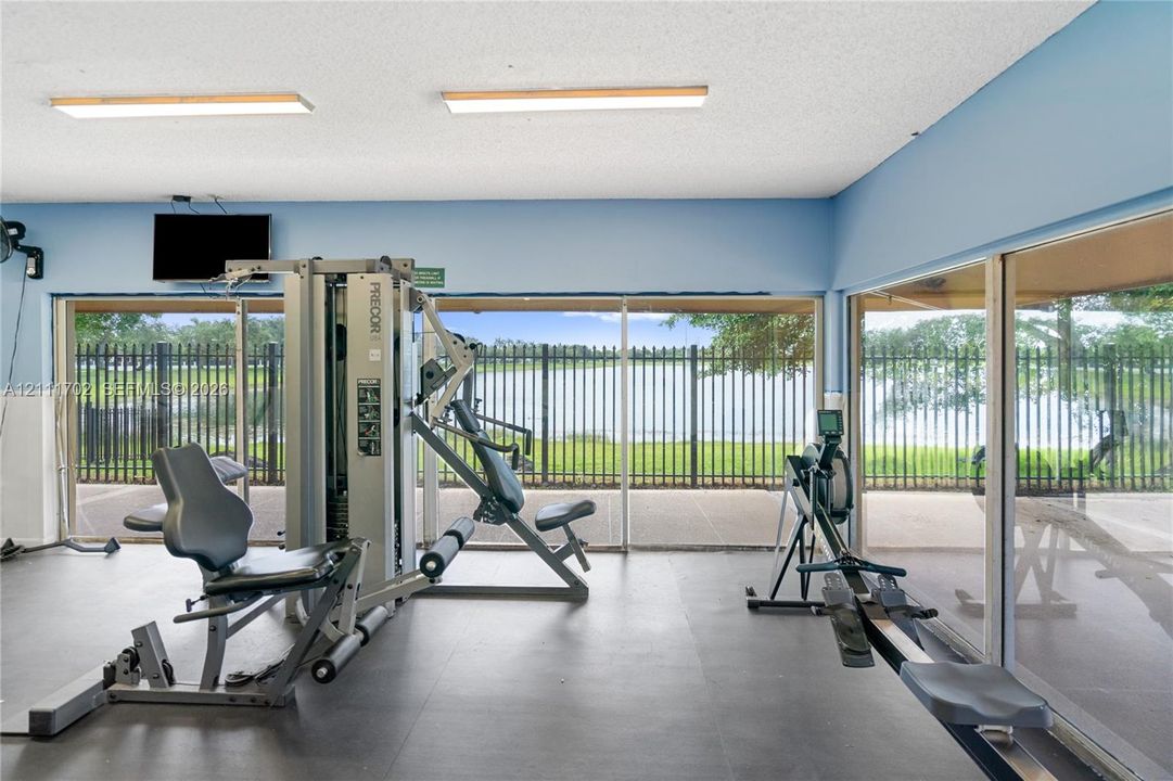 Fitness area featuring expansive floor-to-ceiling windows and solid-surface flooring
