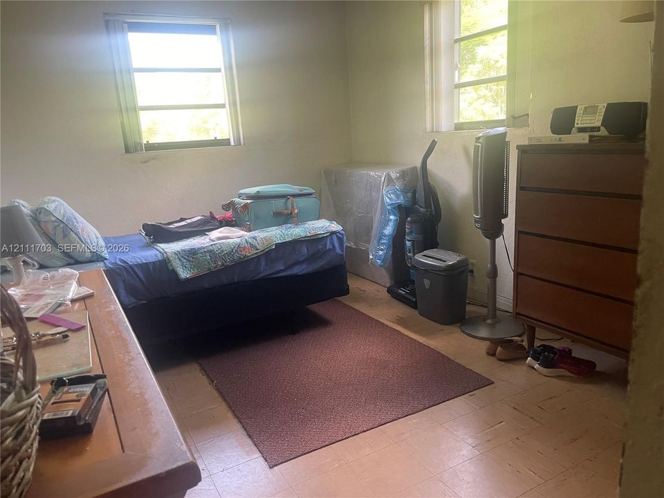 Room with light-toned tiled flooring, dual windows with natural light, and neutral wall surfaces