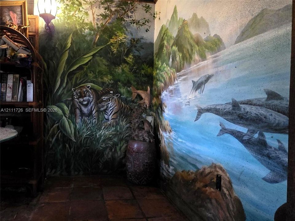 Custom wall murals featuring detailed nature and wildlife imagery, accompanied by tile flooring and a wall-mounted light fixture