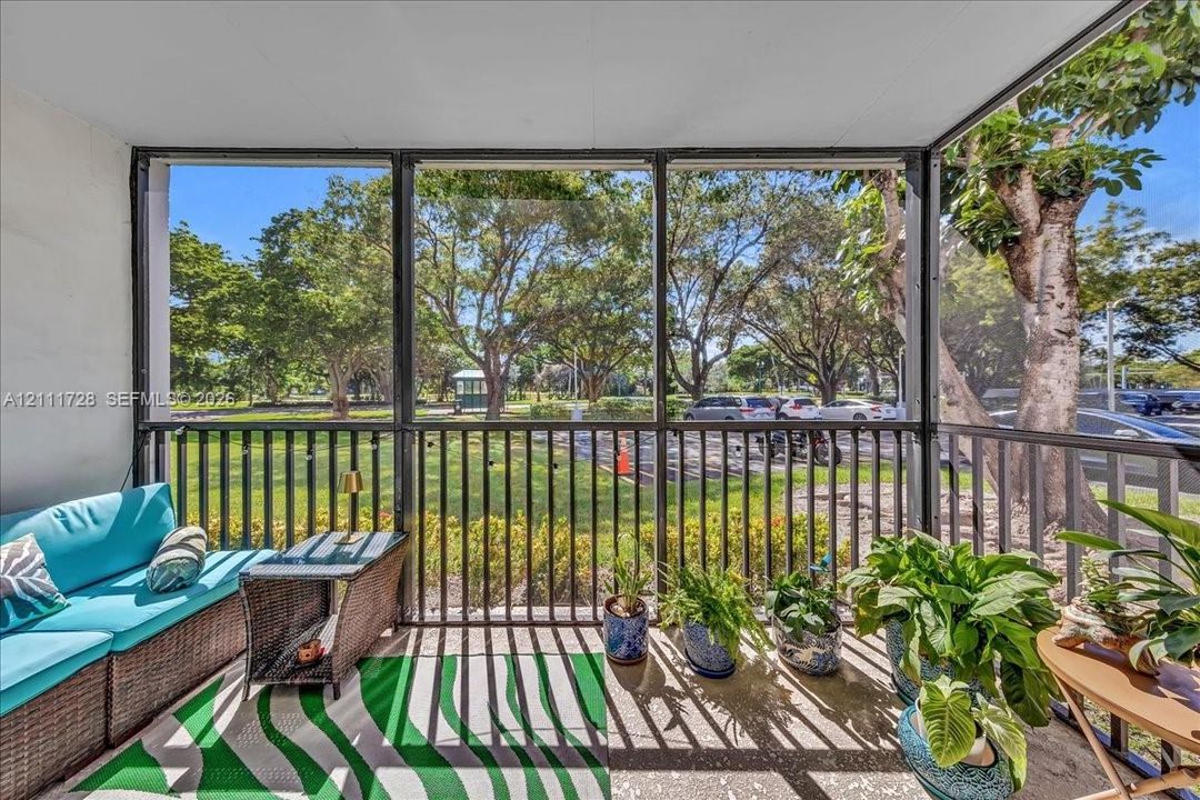 Screened-in porch featuring metal framing, solid ceiling, and concrete flooring