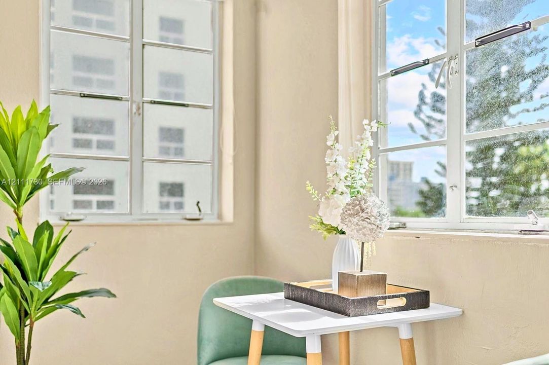 Multi-pane casement windows with light-colored frames, neutral wall finishes, and clean architectural lines