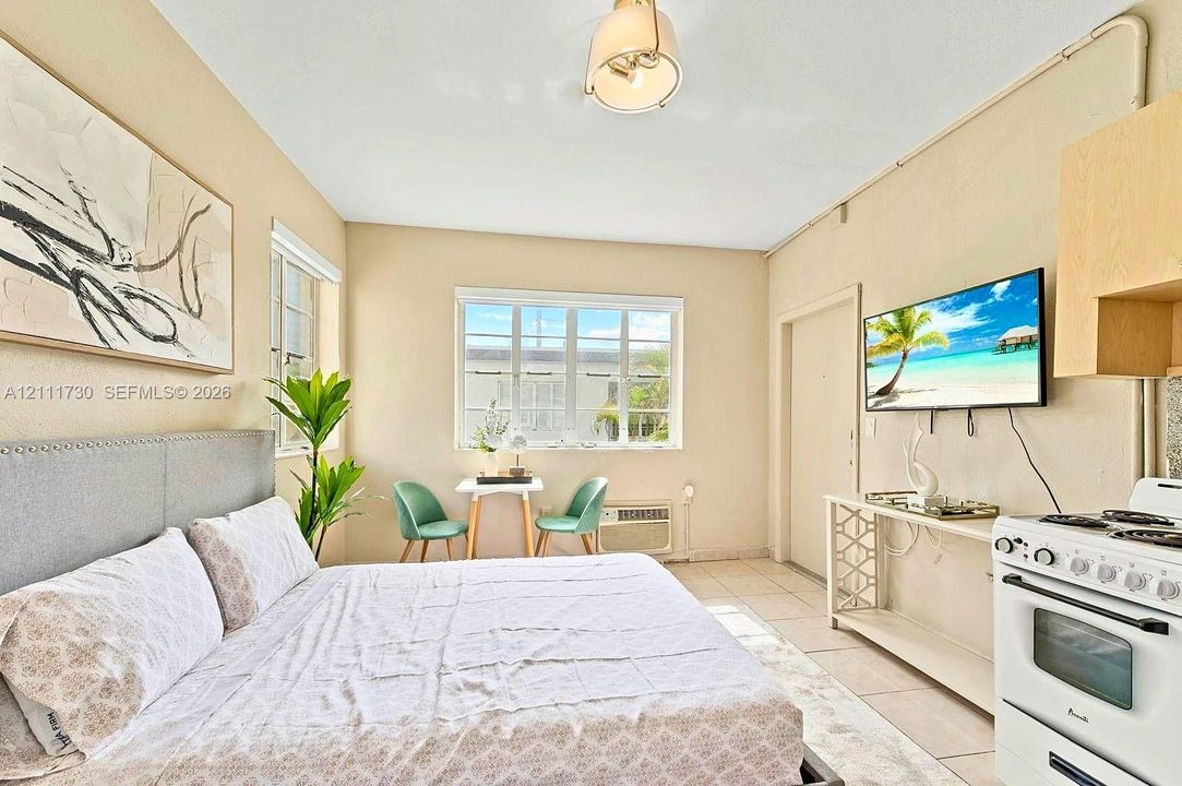 Multi-pane window providing natural light, neutral wall finishes, tile flooring, and integrated overhead lighting