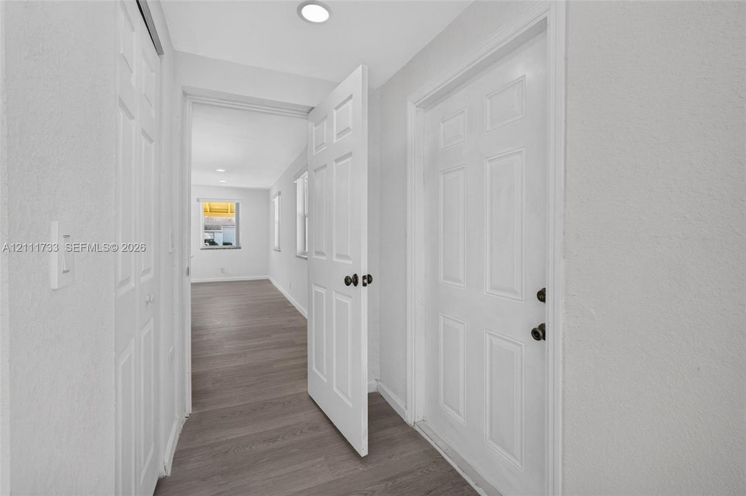 Open (Lock-off) Entry to and from rear bedroom, and Separate closed entry door to right.