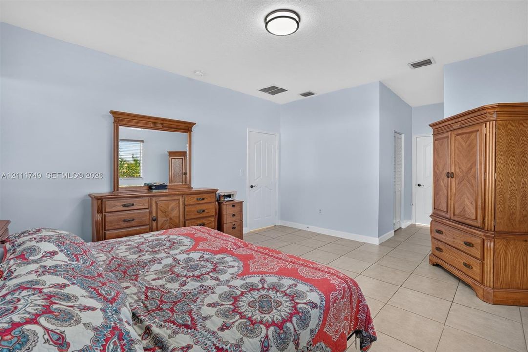 Ceramic tile flooring, neutral wall tones, and recessed ceiling lighting