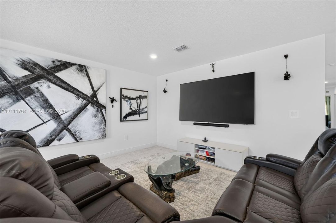 Interior space featuring neutral wall tones, recessed lighting, and wall-mounted light fixtures