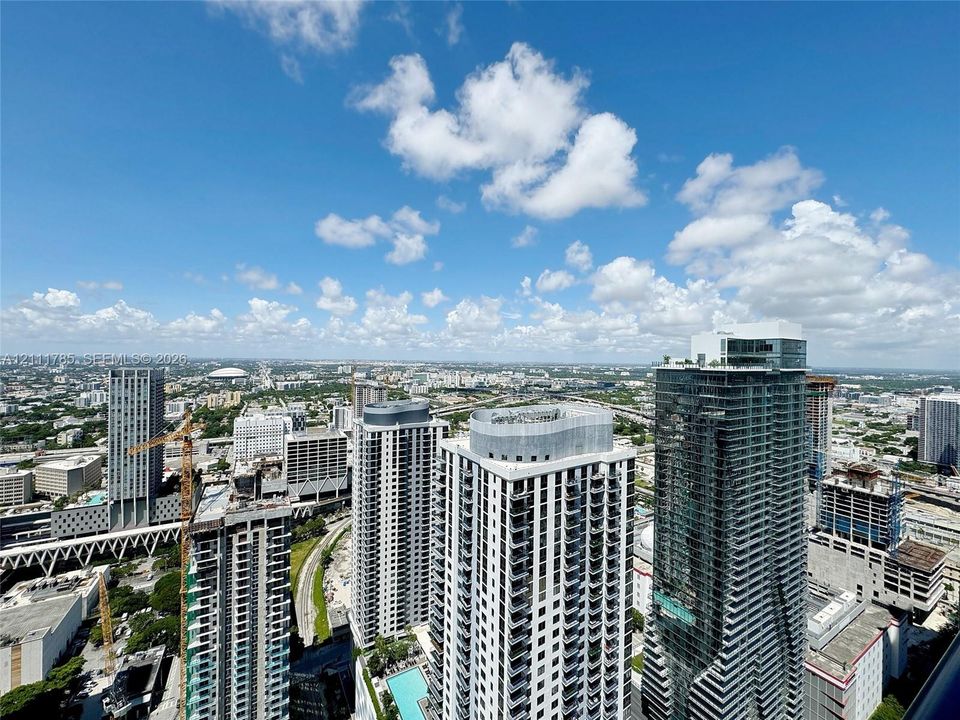 High-rise perspective featuring panoramic urban scenery and glass-facade residential towers
