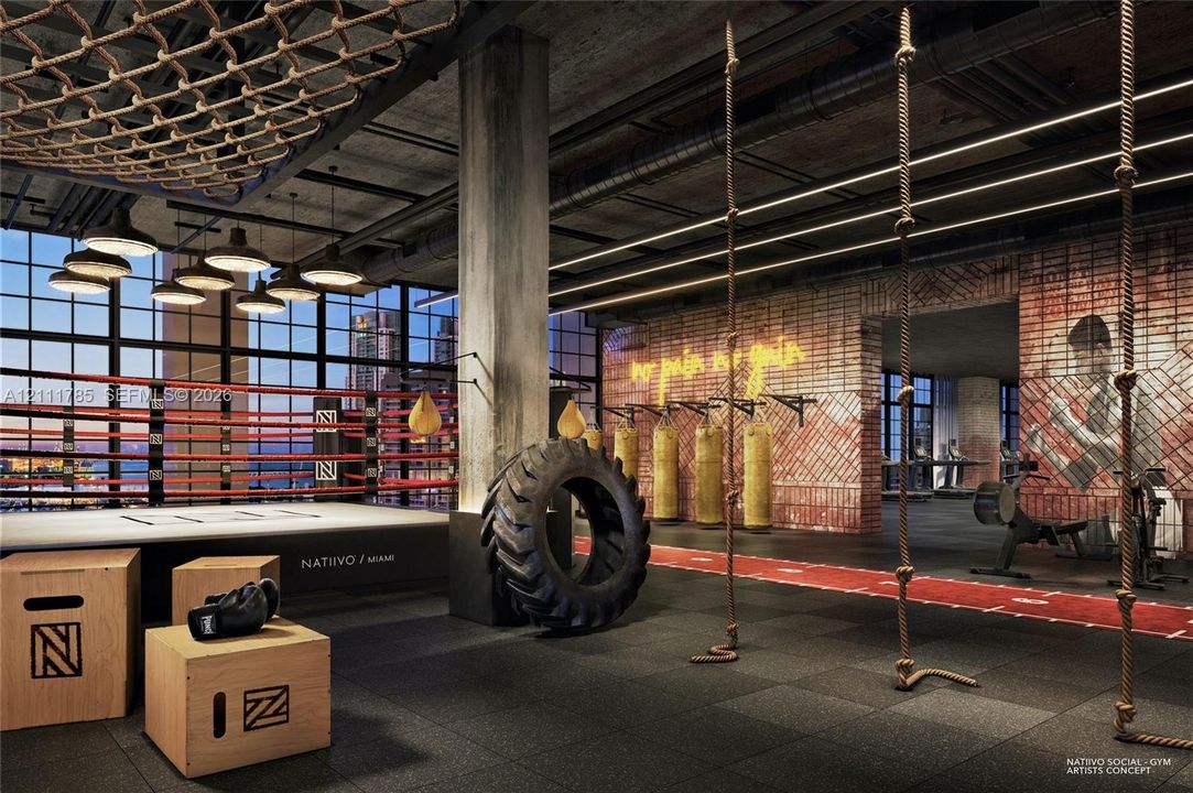 Industrial-style fitness space featuring exposed concrete structural columns, high-rise grid windows, raw brick wall finishes, and exposed ceiling ductwork