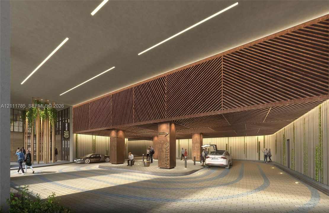 Covered motor court featuring intricate wood-slat ceiling detailing, integrated linear lighting, paver drive surfaces, vertical pillar accents, and architectural wall paneling
