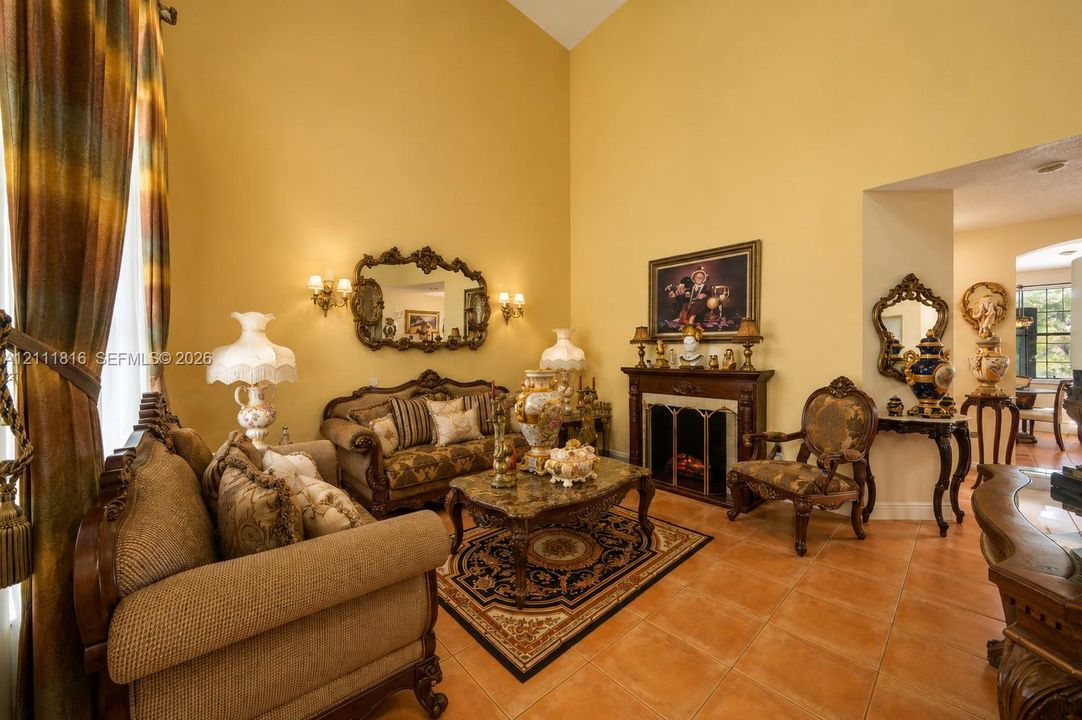 Vaulted ceilings, fireplace with an ornate wood-finish mantel, and tile flooring